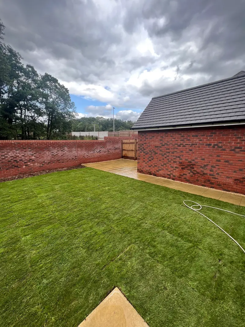 New lawn bordered by a garden wall
