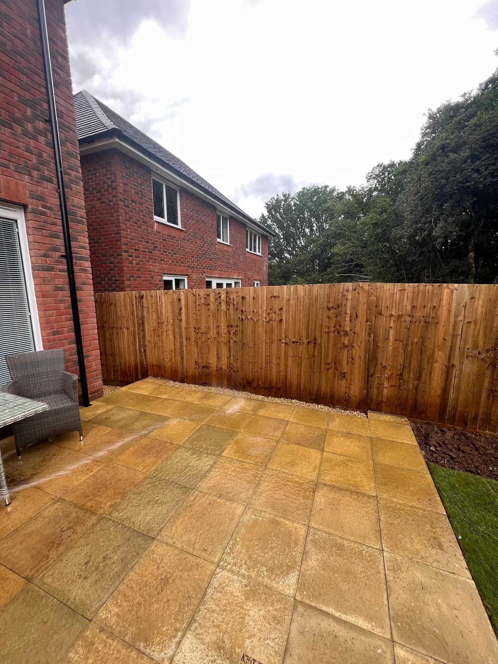 Golden sandstone patio with new fencing
